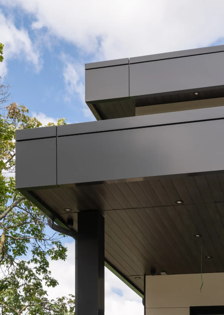 Close-up of black aluminum soffit and fascia on a modern North York home, featuring clean lines, recessed lighting, and durable baked enamel finish by Vedrex