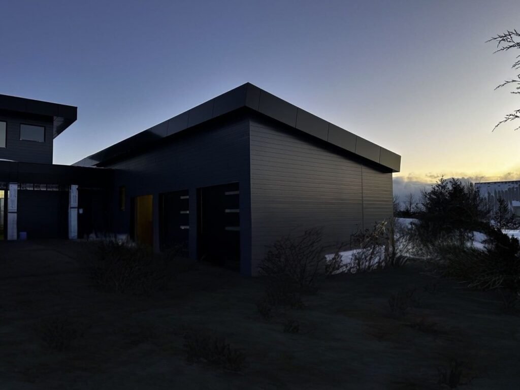 Modern building featuring horizontal dark gray aluminum siding under a twilight sky with a slight sunset glow.