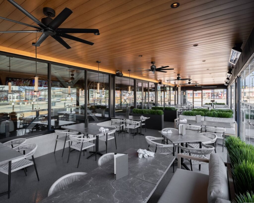 A daytime photo of Moxie's Barrie patio, featuring premium VEDREX Carpino aluminum soffit.