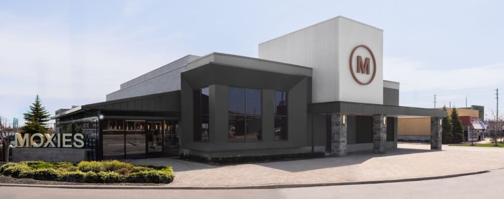A daytime photo of the exterior of Moxies Barrie, clad with premium Vedrex white wood aluminum siding.