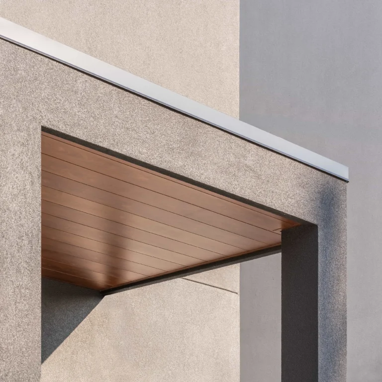 Wood-grain aluminum soffit on a modern Toronto brick and stone home showing premium soffit types for houses