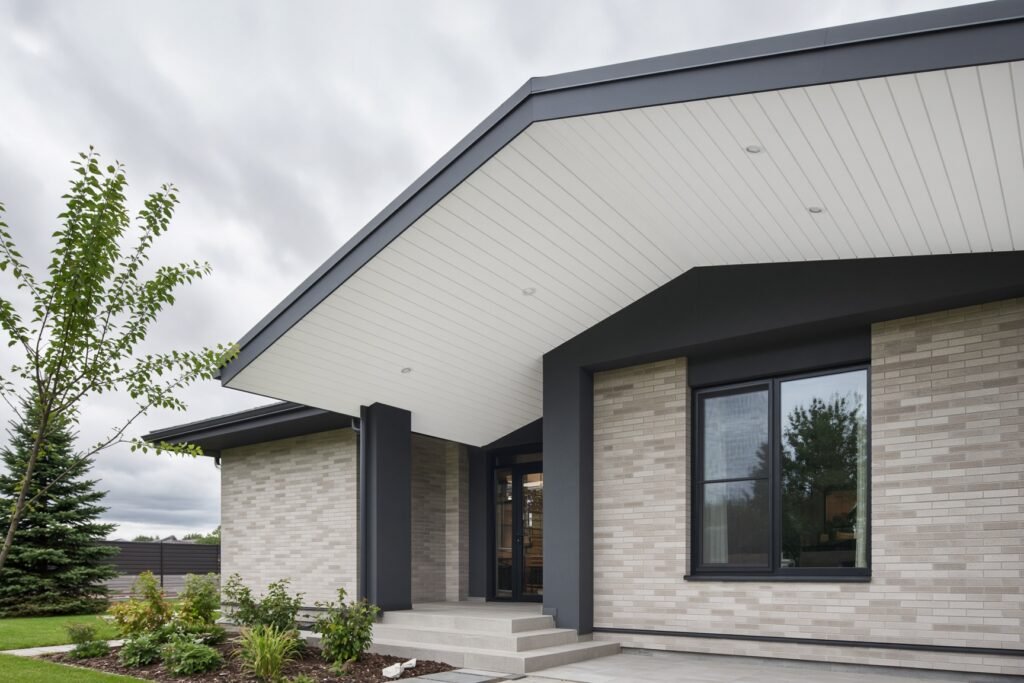 A clean architectural exterior photograph of a modern residential home with crisp white aluminum soffit under the roof overhang.