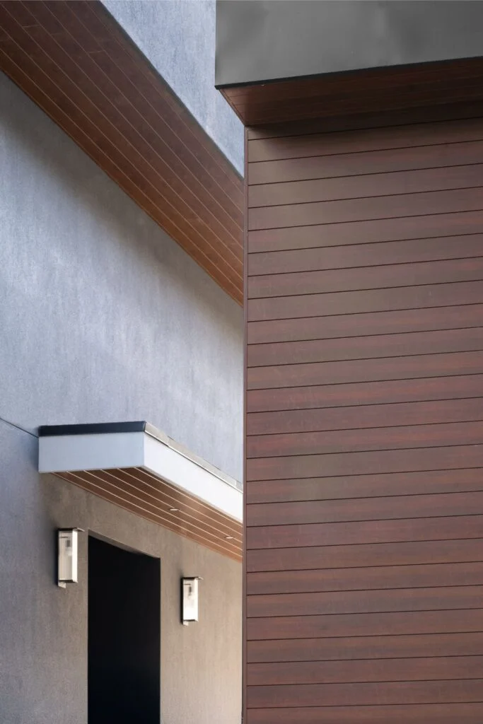 VEDREX wood grain aluminum siding and matching soffit on a modern home exterior