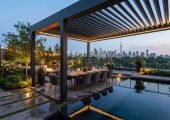 Aluminum pergola overlooking Toronto skyline at night with city lights